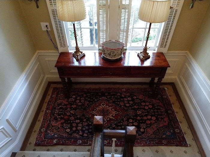 I relocated the Nadeau sofa table to the stair landing, burned all the old family photos and made it look much more inviting. It's a gift...