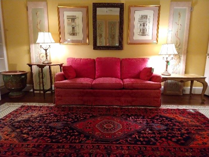 A quiet and restful upstairs sitting room, with hand painted door panels, red damask couch, Italian Florentine coffee table, pair of 4-light table lamps, large glazed ceramic urn, pair of nicely framed and matted architectural prints and a decent mirror.