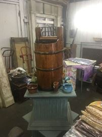 Pair of architectural columnar tables holding a selection of North Carolina pottery and a Chinese rice bucket.