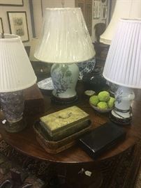 Three of several Chinese porcelain vases made into lamps resting on an American drop leaf dining table, circa 1815.