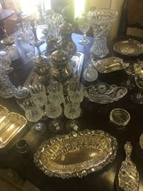 One of the entry period dining tables set with period 19th and early 20th century glassware and silver plate.