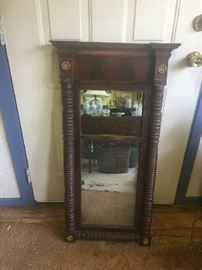 American classical period mahogany mirror with columns flanking the glass, circa 1825.