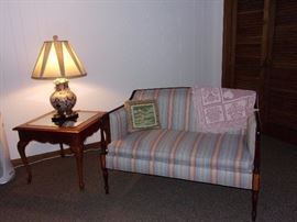 Settee, glass top end table and lamp