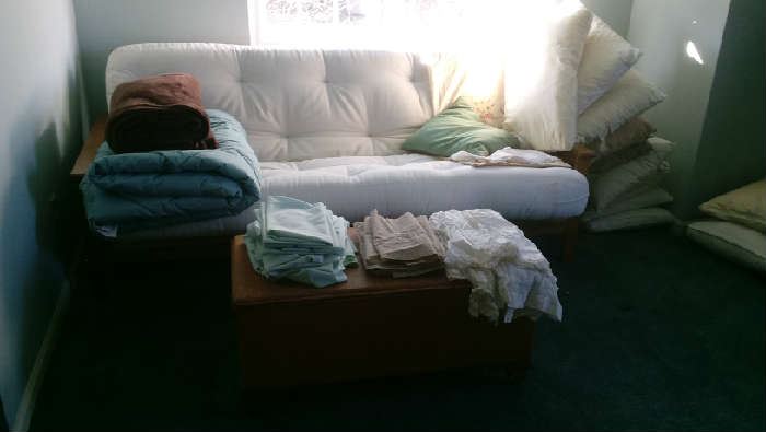 Futon, blankets, pillows, blanket chest