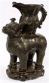 16 - CHINESE, BRONZE PITCHER, BEING CARRIED BY FOO DOG, H 13"5", W 10"