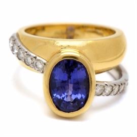 Diana Vincent 18K Yellow Gold and Platinum Diamond and Tanzanite Ring: A Diana Vincent 18K yellow gold and platinum diamond and tanzanite ring. This ring features a bezel set amethyst stone with a double band featuring prong set diamonds along the shoulders.
