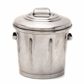 Cartier Sterling Silver Figural Garbage Can Vessel: A Cartier sterling silver vessel in the shape of a garbage can. It features the traditional garbage can style with a unhinged lid and handles to the side. The underside is marked, “Cartier Sterling 667” with a total weight of 1.460 ozt.