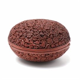 Early 19th-Century Chinese Carved Cinnabar Trinket Box: An early 19th-century Chinese carved cinnabar trinket box, c. 1810-20. The box is heavily lacquered on the both the exterior and interior. The exterior displays high relief floral carvings in fine detail to either side.