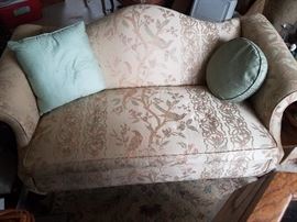 ONE OF A PAIR OF CAMEL BACK LOVE SEATS