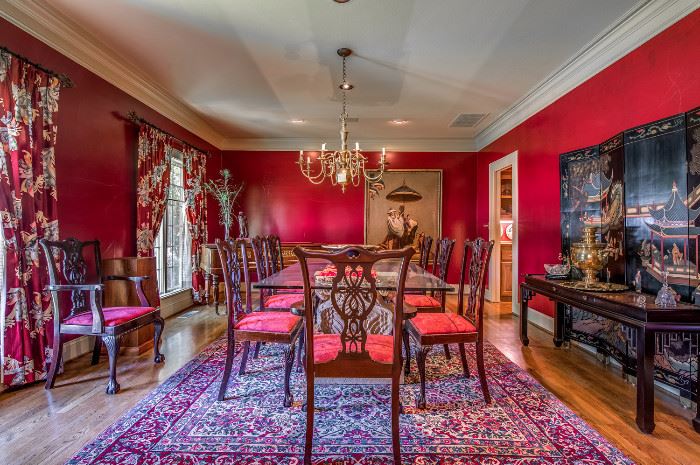 Elegantly appointed dining room with beautiful set of Chippendale chairs, glass top table, fine carpet, screen, antique piano.