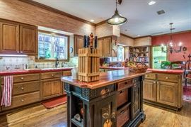 Lovely black tole painted island in the kitchen has a separate top and drawers and baskets that pull out from either side.  (SOLD AT PREVIEW)