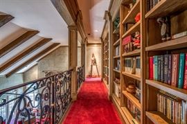 Upstairs library wall features many, many books and some decorator pieces.