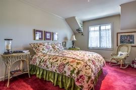 Upstairs bedroom features a queen bed with a custom duvet cover and pillow shams (one sham has a tear).  There is a coordinated round table dressing. DUVET COVER AND SHAMS SOLD AT PREVIEW