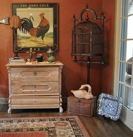 Kitchen dining corner features an antique birdcage from New Orleans, white washed primitive chest, Ben Ortega St. Francis, metal Asian tea kettles.