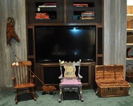 Large flat screen t.v. (one of 3 in the house), children's rockers and a cow push toy
