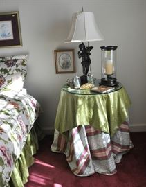 Round accent table has a very thick piece of glass and a high quality angel lamp.