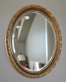 A very nice beveled oval mirror - one of 2.
