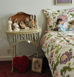 A vintage nativity sits atop an antique wicker table