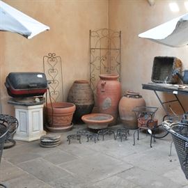 Large pots, wrought iron, plant stands, 2 very cute tables that need tops