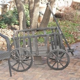 This rustic goat cart has been in the garden for many years.  It can be helped to have more years in the garden or can be re-purposed indoors.