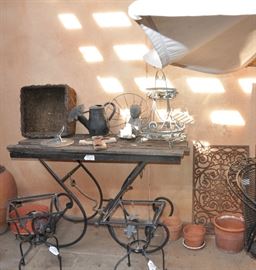 Great, large wrought iron table with aged wood top, Front Gate iron door mats can make wonderful wall decor.