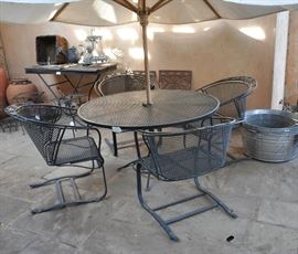 This is the 3rd set of Woodard wrought iron patio furniture.  It also comes with an umbrella, seat cushions and cover.  SOLD AT THE PREVIEW