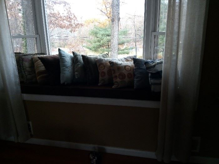 Various pillows and window seat cushions