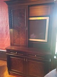 Custom media cabinet made of solid walnut includes Bang and Olufson TV