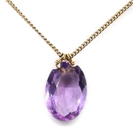 Amethyst Pendant on a Gold Filled Chain: An amethyst pendant on a gold filled chain.