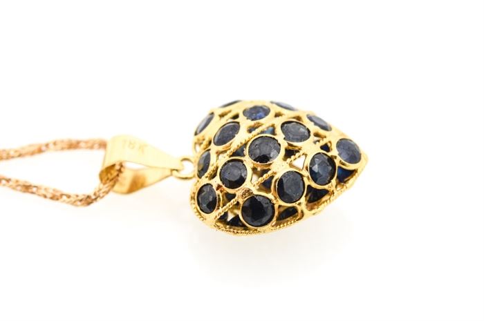 18K Yellow Gold Sapphire Heart Necklace: An 18K yellow gold sapphire heart necklace.