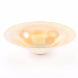 Iridescent Bowl: An iridescent bowl. The round bowl features an iridescent gold, pink, and orange-toned topside with a white underside. It is somewhat legibly marked to its underside, “Orene 16.”