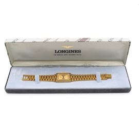 Longines QWR Wristwatch: A vintage Longines wristwatch with textured link band. The bezel and dial offer a modernist flair, with textured dial face and simple hour markers complemented by minimalist hands.