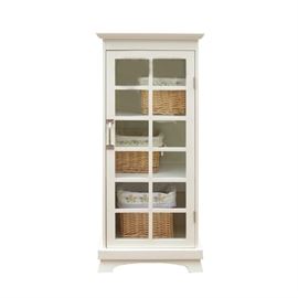 Glass-Front White Cabinet with Baskets: A cabinet unit with three wicker baskets. The wooden cabinet is painted in a white finish and features a mullioned, single-pane glass door with a silver-toned hardware. Enclosed in the cabinet space are three shelves with three, cloth-lined wicker baskets featuring embroidered floral designs. Cabinet is unmarked.