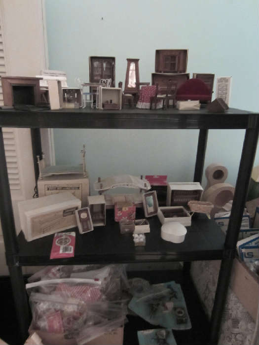 Miniature dolls and dollhouse furniture.