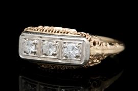 14K Yellow Gold and Diamond Three Stone Filigree Ring: A 14K yellow gold and diamond three stone filigree ring.