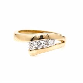 14K Yellow Gold Diamond Ring: A 14K yellow gold diamond ring. This ring features four round brilliant cut diamonds in an open channel setting.