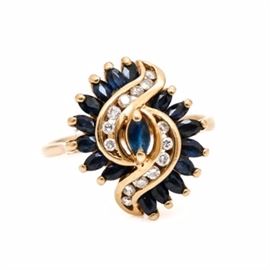 14K Yellow Gold Sapphire and Diamond Ring: A 14K yellow gold sapphire and diamond ring. This ring features seventeen faceted marquise sapphires in a prong setting and fourteen round brilliant cut diamonds.
