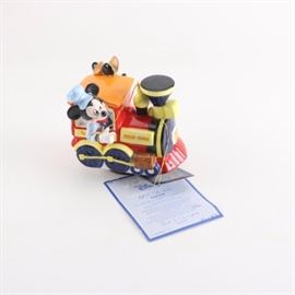 Disney "Mickey Mouse and Minnie Mouse 60th Birthday" Limited Edition Music Box: A Disney music box titled Mickey Mouse and Minnie Mouse 60th Birthday. This limited edition Schmid music box is number 1,921 of a limited edition of 7,500. It depicts Mickey and Minnie in a train and includes a COA.