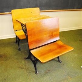 Antique New Peabody School Desk: An antique New Peabody school desk. This school desk features cast iron and wood construction with a folding seat, ink well holder and pencil groove. Marked New Peabody to sides.