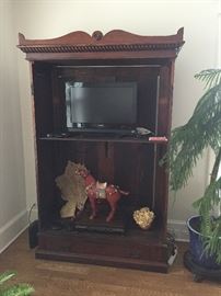 Vintage armoire being used as television cabinet. Cinnabar horse.