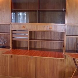 Wall unit opens to reveal a roomy desk.  Unit is also lighted