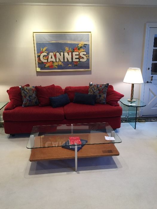 Glass and wood coffee table.  Red upholstered sofa in great condition.  End table is by Pace and lamp is one of a pair by Walter Von Nessen.