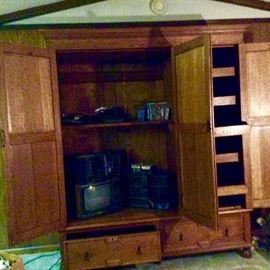 Entertainment center opened. Perfect if rod added to hang clothing and drawer storage for clothing.