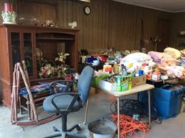 Garage full of miscellaneous items including an entertainment center.