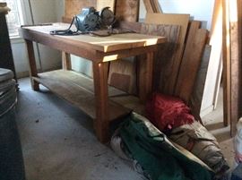 Work bench with Grinder. Two tents on floor.