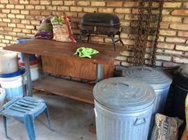 Work table/bench, tabletop grill, heavy chains, Vintage metal trash cans.