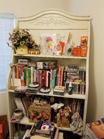 Large bookcase. Lots of books on collecting antiques, cookbooks