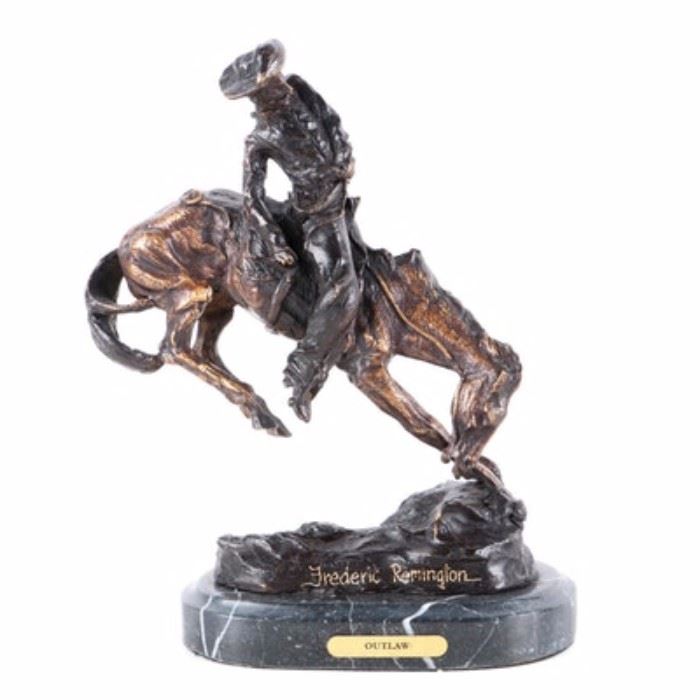 Bronze Tone Reproduction Sculpture After Fredric Remington "Outlaw": A bronze tone reproduction sculpture after an original work titled Outlaw by Frederic Remington. The work depicts a cowboy riding a bucking horse. The piece is signed in-mold and embellished with gold tone ink near the base. The sculpture is mounted on an oval gray marble base with felt padding affixed to the underside.