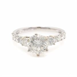 18K White Gold 2.40 CTW Diamond Ring: An 18K white gold and 2.40 ctw diamond ring. This ring showcases a round brilliant cut diamond prong set between ten accent diamonds in a stepped setting.