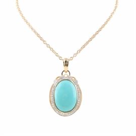 Orianne Gold Wash on Sterling Silver Turquoise and Diamond Necklace: An Orianne gold wash on sterling silver turquoise and 0.50 ctw diamond necklace. This necklace features a bezel set turquoise cabochon that is surrounded by prong set diamonds with milgrain accents and is affixed to a fancy rolo chain.